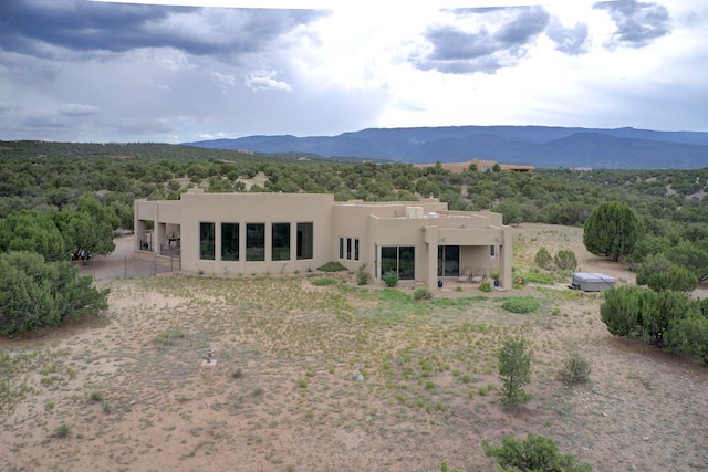 back of house with a mountain view