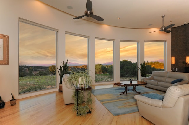 living room featuring ceiling fan and light wood-type flooring