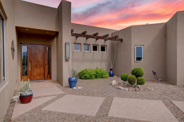 view of exterior entry at dusk