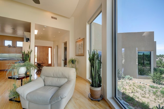 interior space with light hardwood / wood-style flooring and a high ceiling