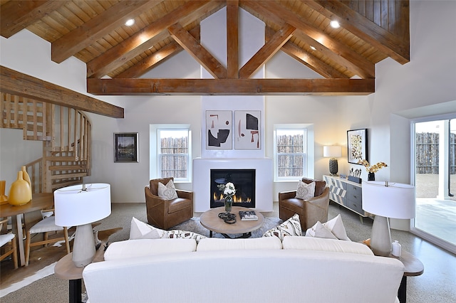 carpeted living room featuring high vaulted ceiling, plenty of natural light, and beam ceiling