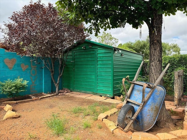view of outbuilding featuring an outdoor structure and fence