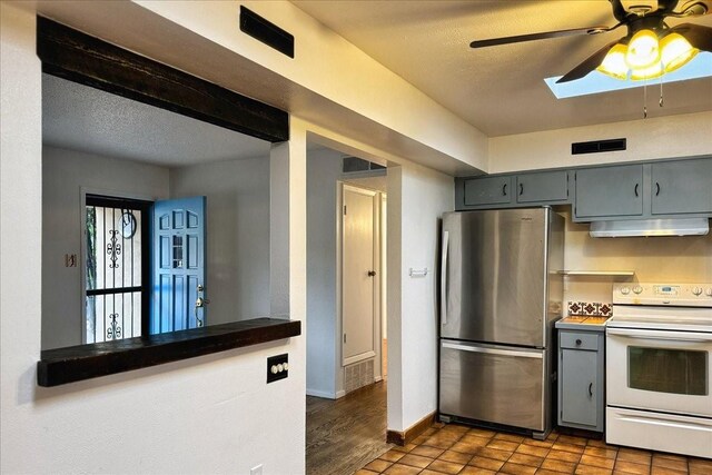 kitchen featuring hardwood / wood-style flooring, stainless steel fridge, white range with electric stovetop, ceiling fan, and a textured ceiling