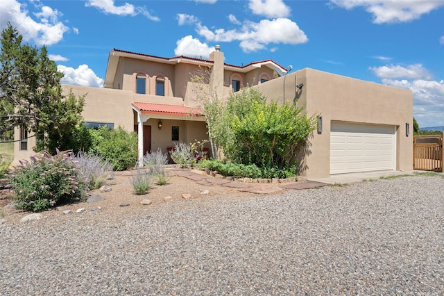 pueblo-style home featuring a garage