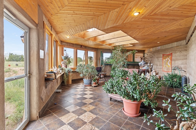 115 Waldo Mesa, Madrid, NM 87010 - unfurnished sunroom with a skylight, wood ceiling, and a healthy amount of sunlight