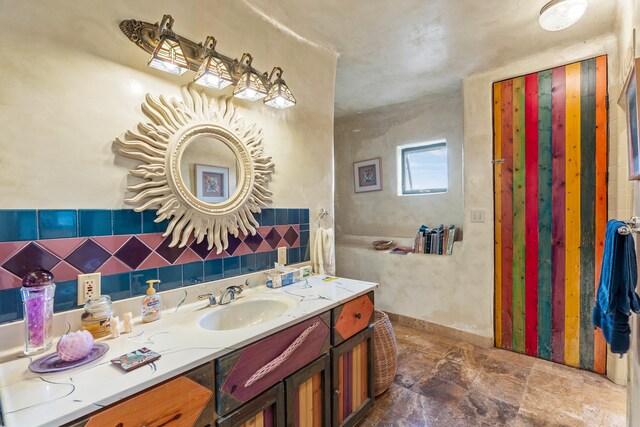 115 Waldo Mesa, Madrid, NM 87010 - bathroom featuring tile walls, vanity, decorative backsplash, and tile patterned flooring
