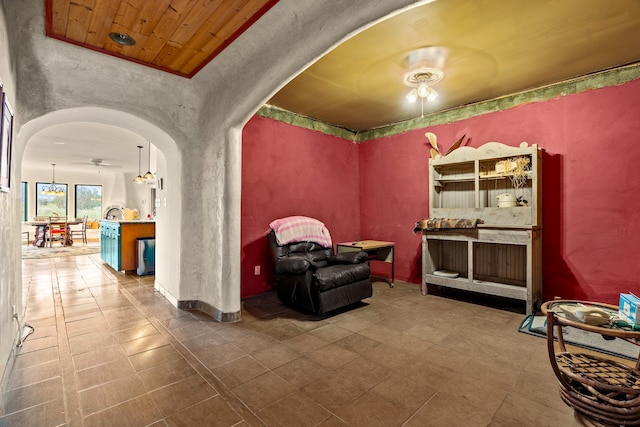115 Waldo Mesa, Madrid, NM 87010 - sitting room featuring ceiling fan, tile patterned floors, and wooden ceiling