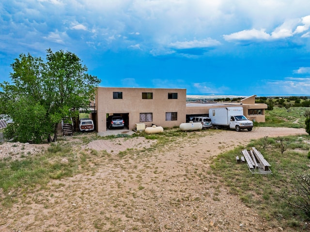 115 Waldo Mesa, Madrid, NM 87010 - back of house featuring a garage