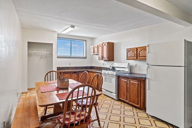 115 Waldo Mesa, Madrid, NM 87010 - kitchen featuring light tile patterned floors and white appliances