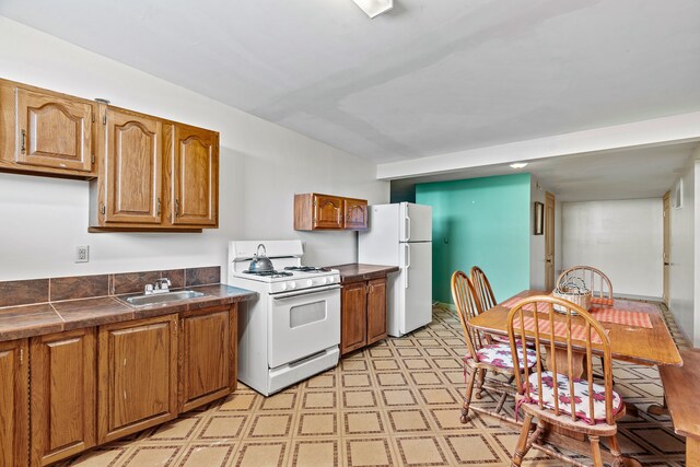 115 Waldo Mesa, Madrid, NM 87010 - kitchen with white appliances, sink, and light tile patterned floors