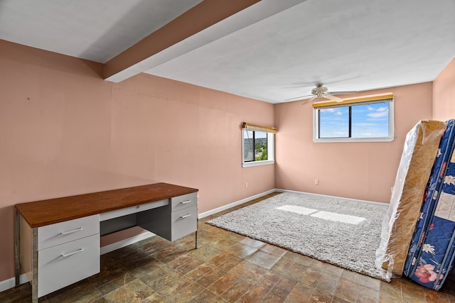 115 Waldo Mesa, Madrid, NM 87010 - home office with ceiling fan, built in desk, and dark tile patterned flooring