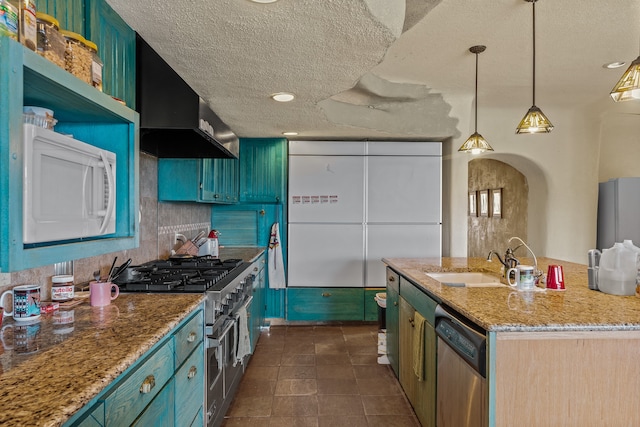 115 Waldo Mesa, Madrid, NM 87010 - kitchen with a textured ceiling, stainless steel appliances, a kitchen island with sink, light stone countertops, and wall chimney range hood