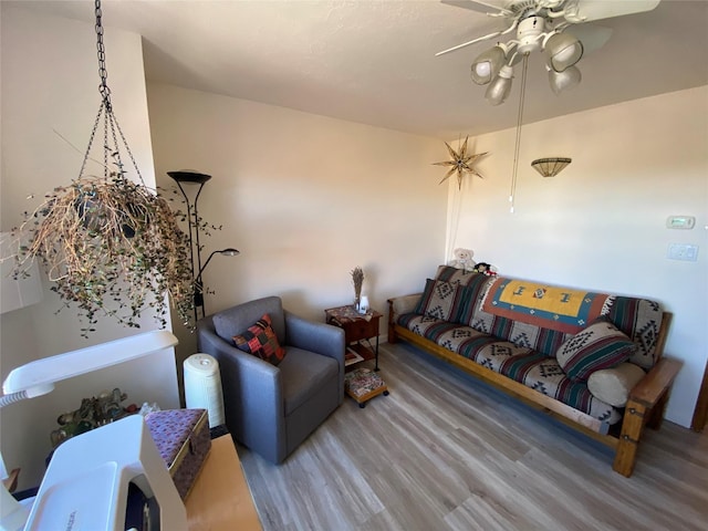 living room featuring ceiling fan and wood finished floors