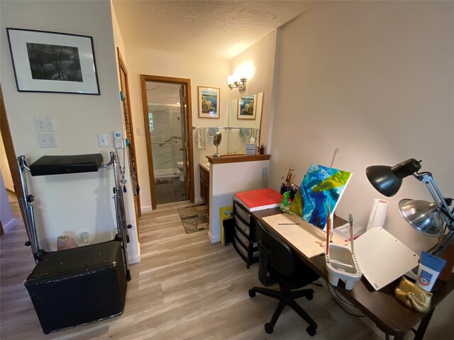 office area with hardwood / wood-style flooring and a textured ceiling