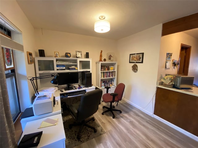 home office with hardwood / wood-style floors