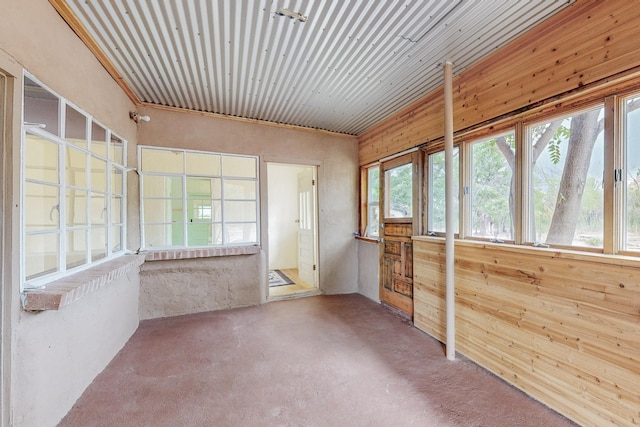 unfurnished sunroom with wooden ceiling