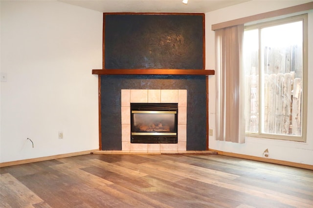 unfurnished living room with a fireplace and hardwood / wood-style floors