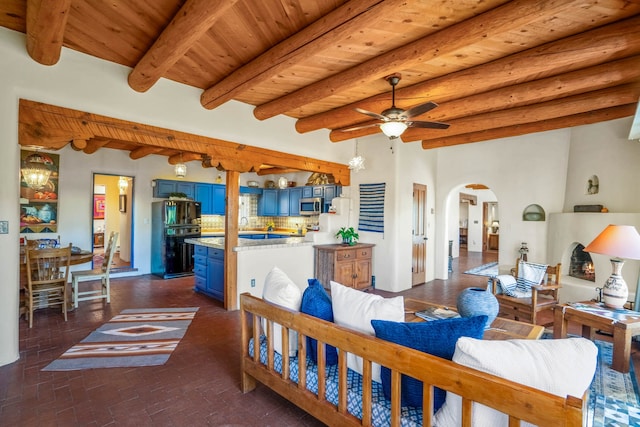 living room with wood ceiling, ceiling fan, and beam ceiling