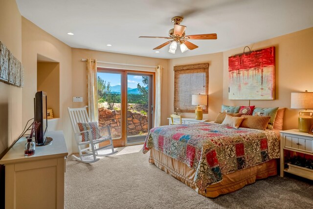 carpeted bedroom featuring ceiling fan and access to exterior