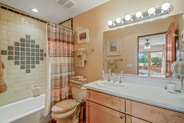 full bathroom with shower / bath combination with curtain, toilet, vanity, and ceiling fan