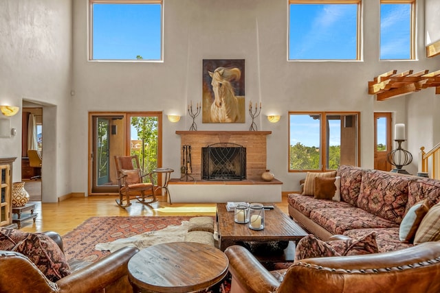 living room featuring light hardwood / wood-style flooring and a towering ceiling