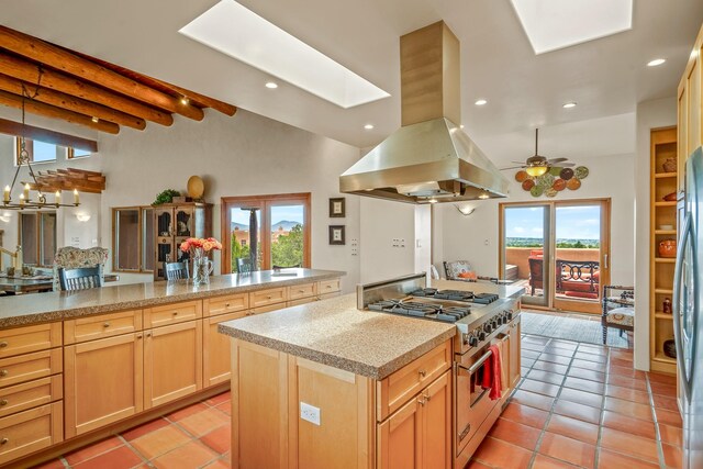 kitchen featuring ceiling fan, island range hood, high end range, and light tile patterned floors