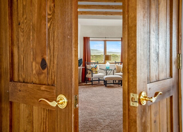 doorway to outside with carpet floors