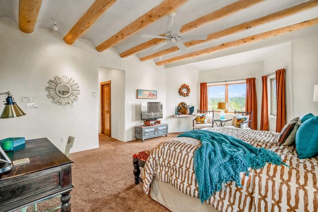 carpeted bedroom featuring beamed ceiling and ceiling fan