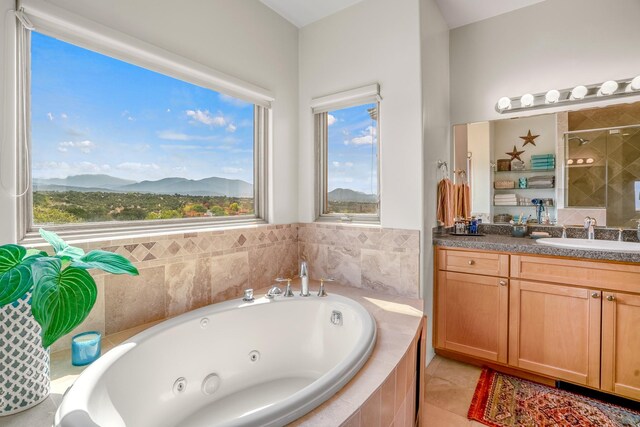 bathroom featuring tiled shower, a mountain view, tile patterned floors, and vanity