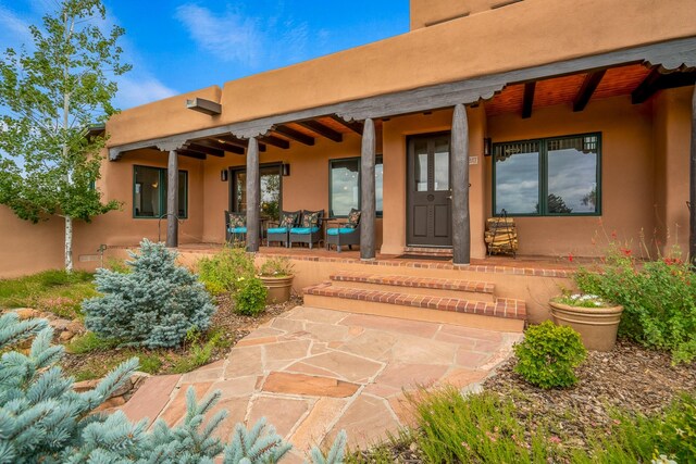 doorway to property with a patio area