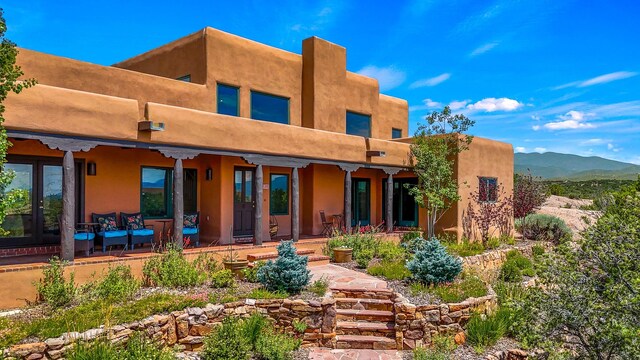 back of property featuring a mountain view