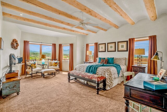 bedroom with beamed ceiling, ceiling fan, and carpet floors