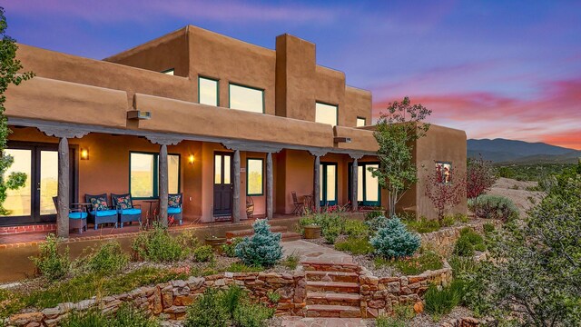 view of back house at dusk