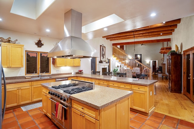 kitchen featuring island exhaust hood, light tile patterned floors, a kitchen island, and high end stove