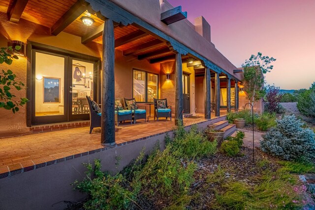 patio terrace at dusk featuring an outdoor living space