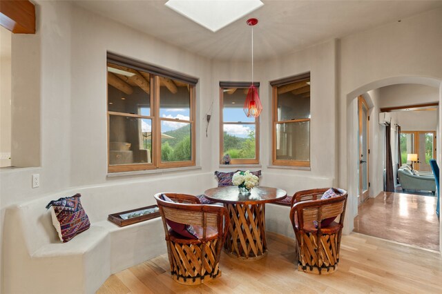 dining area with light wood-type flooring and a healthy amount of sunlight