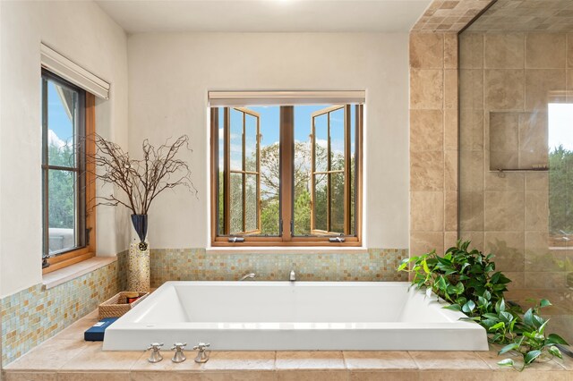 bathroom featuring a relaxing tiled tub