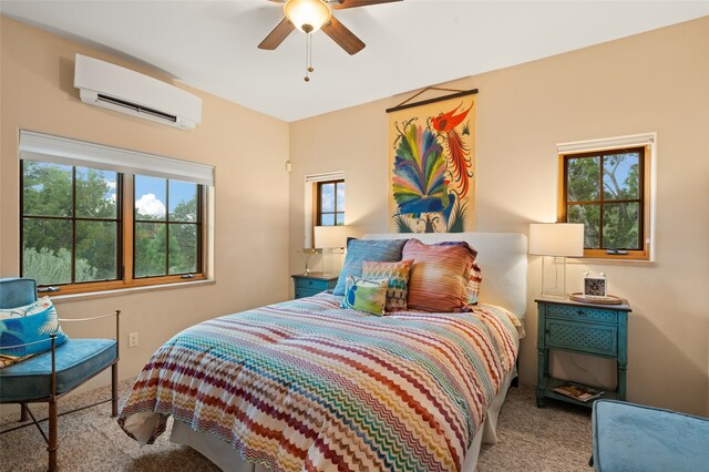 carpeted bedroom with ceiling fan and an AC wall unit