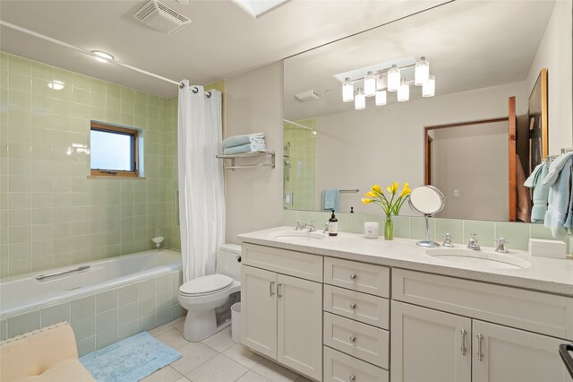 full bathroom featuring shower / tub combo with curtain, tile patterned floors, dual bowl vanity, and toilet