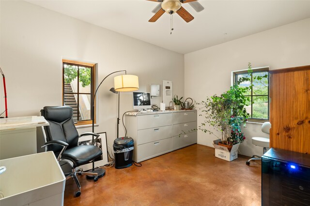 interior space with ceiling fan and concrete flooring