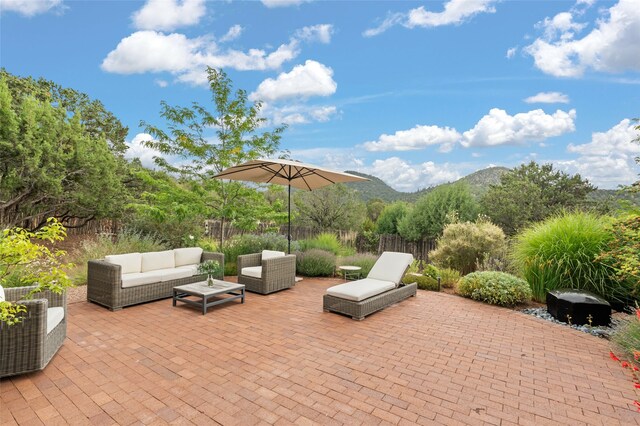 view of patio with outdoor lounge area and a mountain view