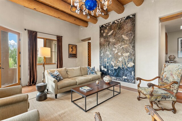 living room with wood-type flooring, beamed ceiling, and an inviting chandelier