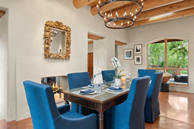 tiled dining room featuring beamed ceiling, an inviting chandelier, and a high ceiling