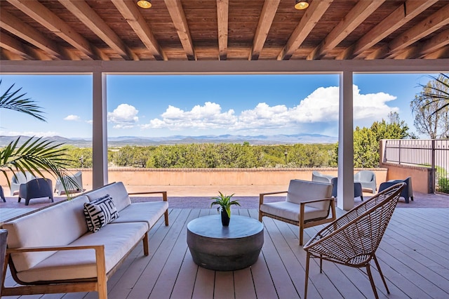 wooden deck with fence and an outdoor hangout area