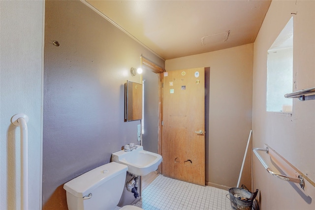 bathroom with sink, toilet, and tile patterned flooring