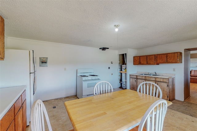 dining area featuring a textured ceiling and sink