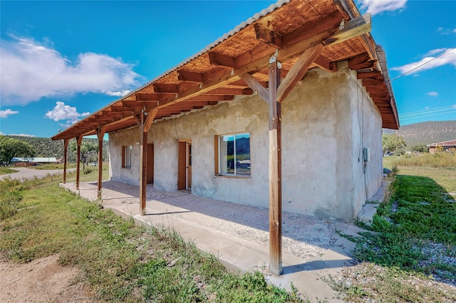 view of side of home with a patio area