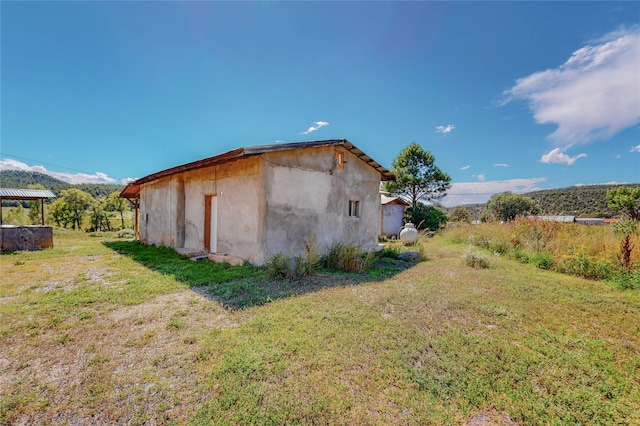 view of home's exterior with a yard