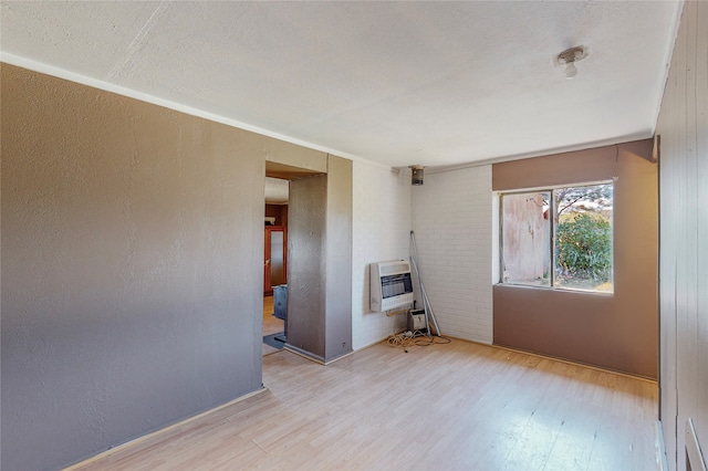 empty room featuring a textured ceiling and hardwood / wood-style flooring