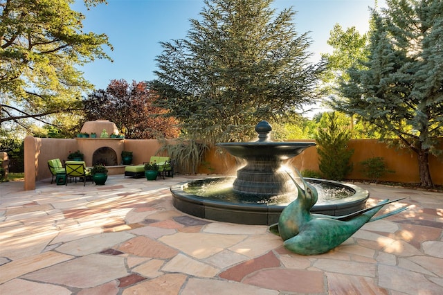 view of patio / terrace with exterior fireplace